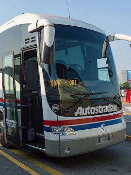 Autostradale tour bus parked at a station in Italy.