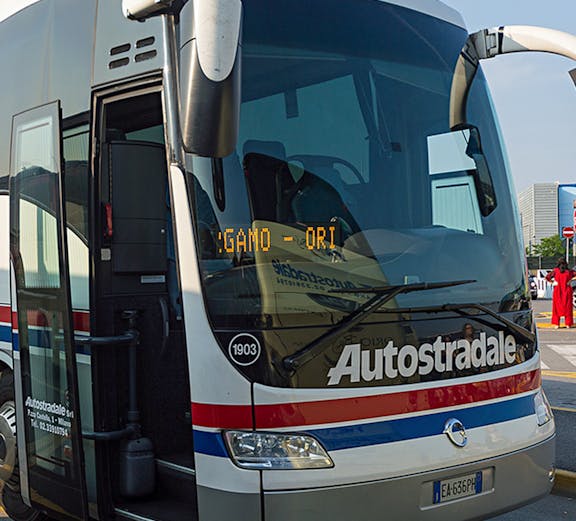 Autostradale tour bus parked at a station in Italy.
