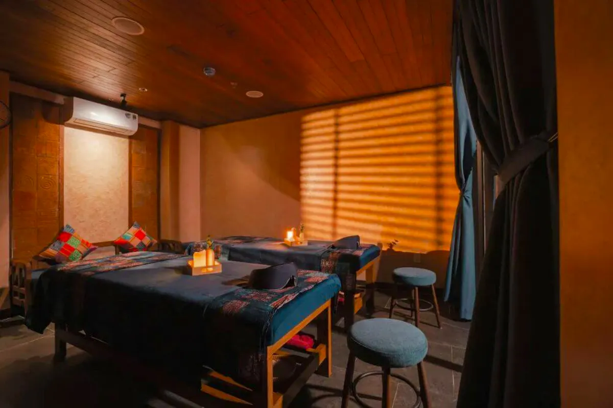 Herbal Spa treatment room with massage tables and ambient lighting in Da Nang.