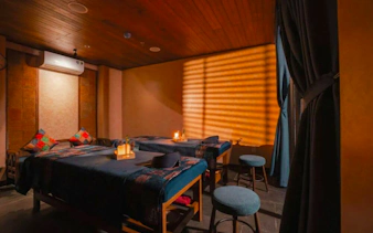 Herbal Spa treatment room with massage tables and ambient lighting in Da Nang.