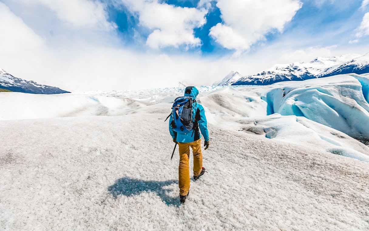 Visitor hiking with guide on Perito Moreno Glacier, Patagonia, Argentina.