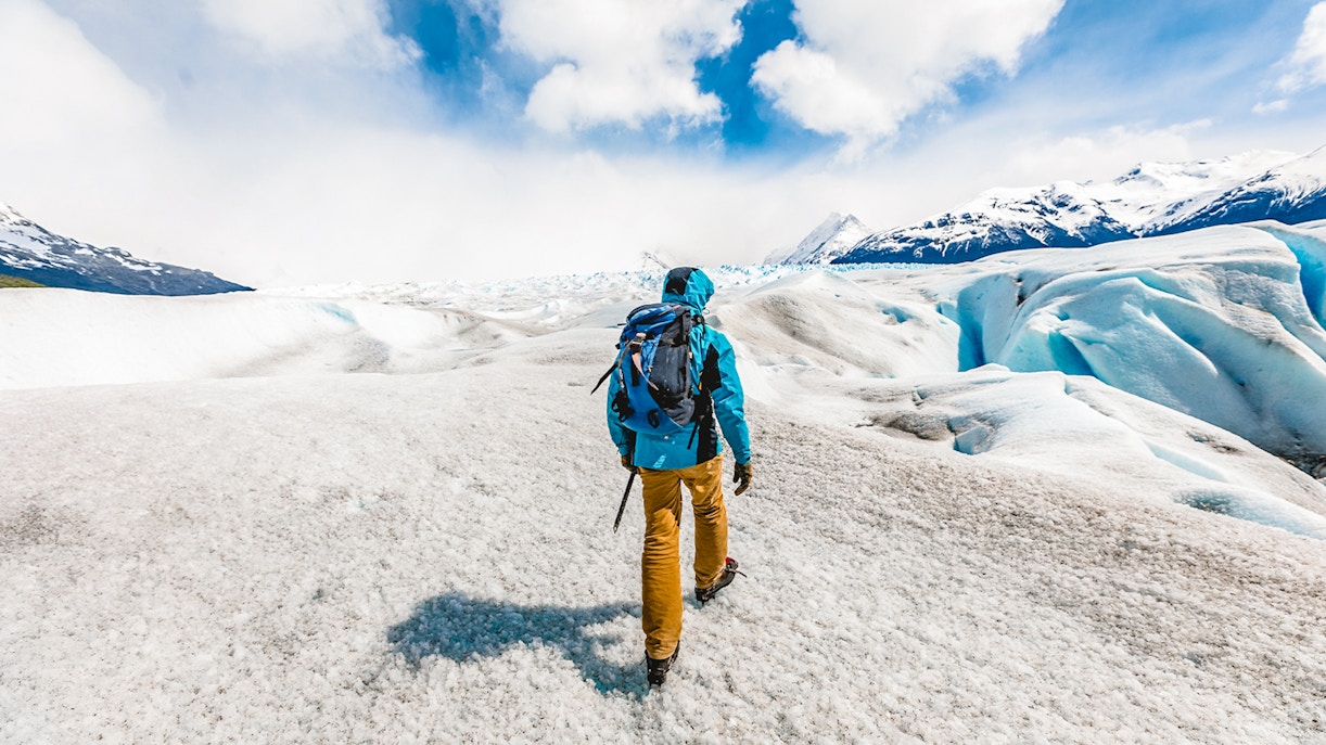 Visitor hiking with guide on Perito Moreno Glacier, Patagonia, Argentina.