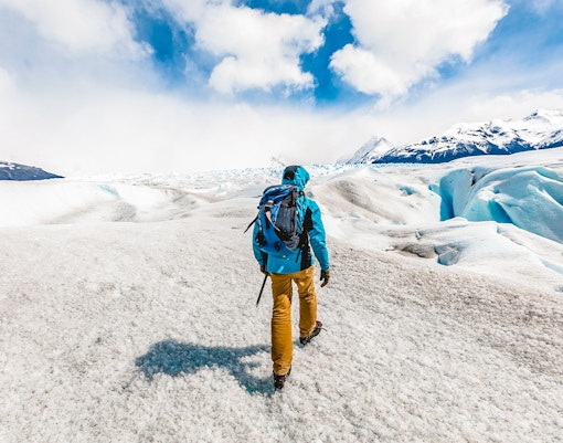 Visitor hiking with guide on Perito Moreno Glacier, Patagonia, Argentina.