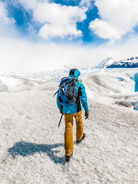 Visitor hiking with guide on Perito Moreno Glacier, Patagonia, Argentina.