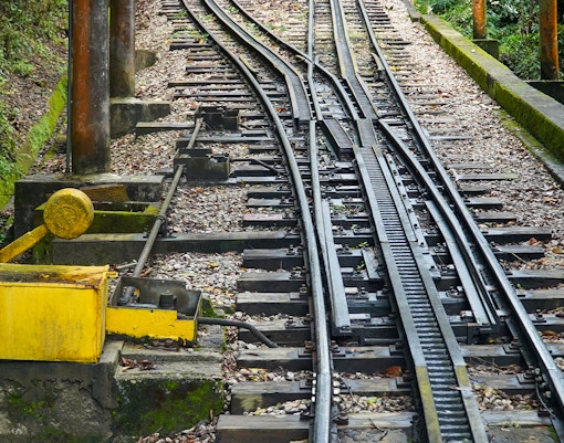 Corcovado mountain railway train ascending through lush forest in Rio de Janeiro, Brazil.