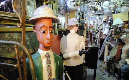 Antique shop with eclectic items at Marché aux Puces de Saint-Ouen, Paris.
