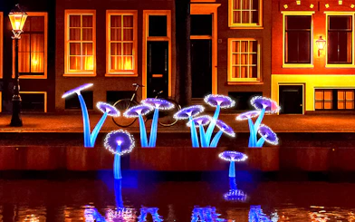 Illuminated art installation resembling mushrooms along Amsterdam canal during Light Festival cruise.