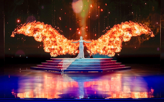 Performer with fiery wings on stage at Colosseum Cabaret Show, Pattaya.