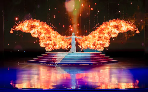 Performer with fiery wings on stage at Colosseum Cabaret Show, Pattaya.