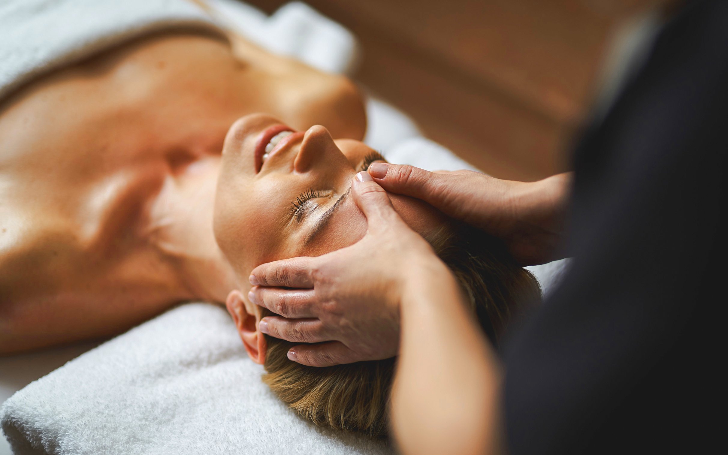 Woman receiving a relaxing head massage at a spa.