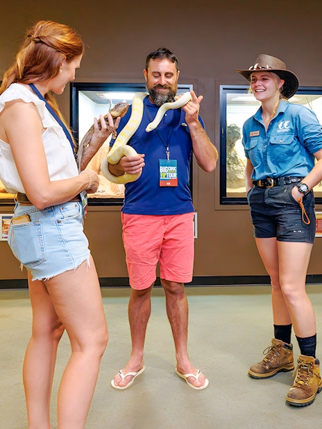 Guests holding snakes at Crocosaurus Cove exhibit.