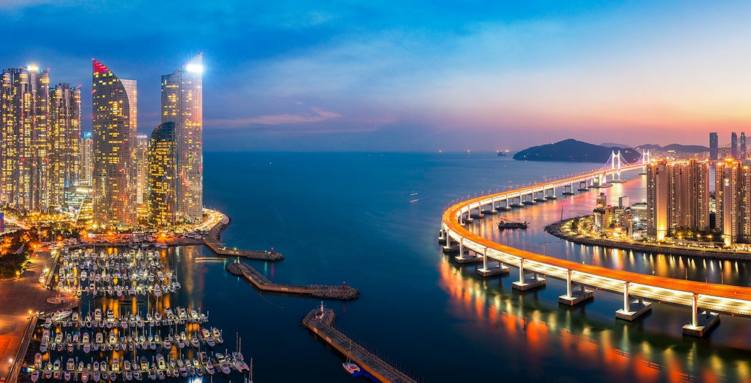 Busan skyline view with Gwangan Bridge and Haeundae Beach, highlighting Busan attraction tickets.