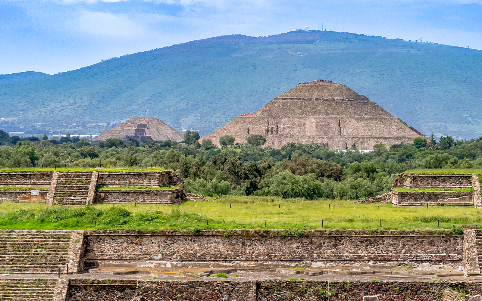 Pyramids of the Sun and Moon at Teotihuacan, Mexico with surrounding greenery.