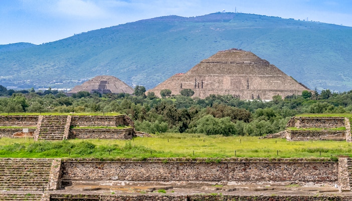 Pyramids of the Sun and Moon at Teotihuacan, Mexico with surrounding greenery.