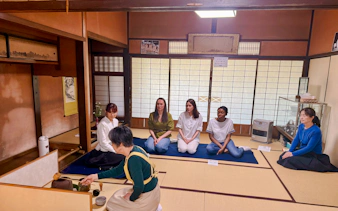 Tea ceremony participants seated in a traditional tatami room at a cultural house in Hyogo.
