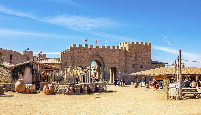Puy du Fou España park medieval village scene with actors in period costumes.