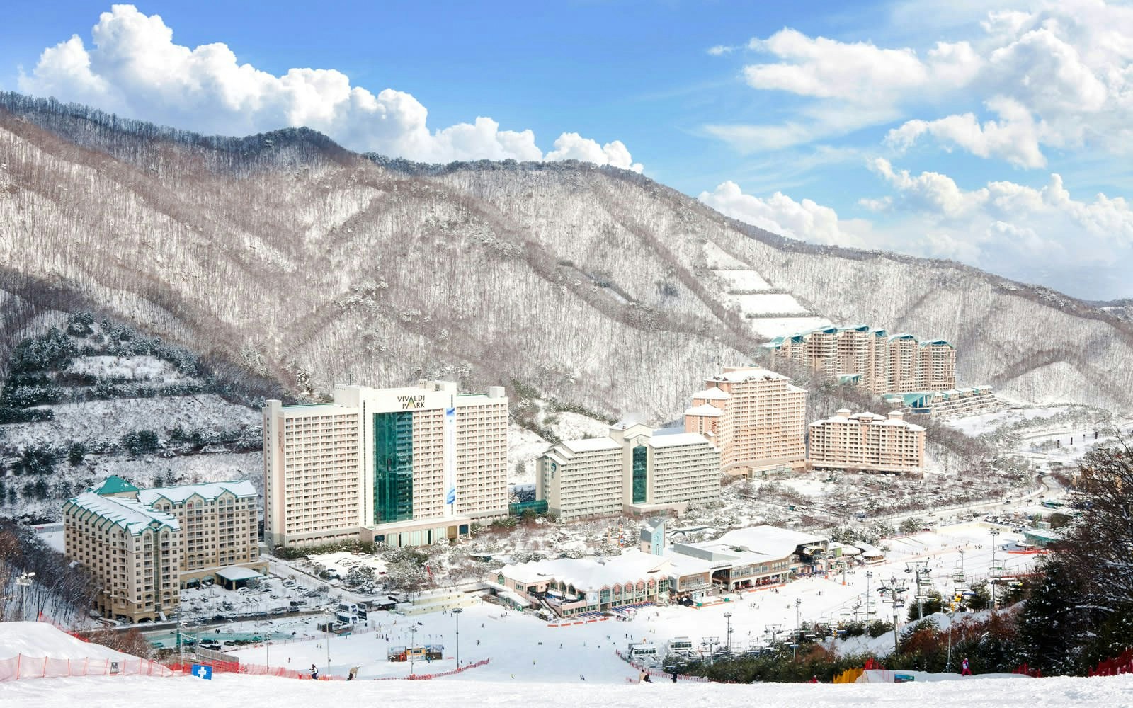 Vivaldi Park Ski Resort with snow-covered buildings and mountains in the background.
