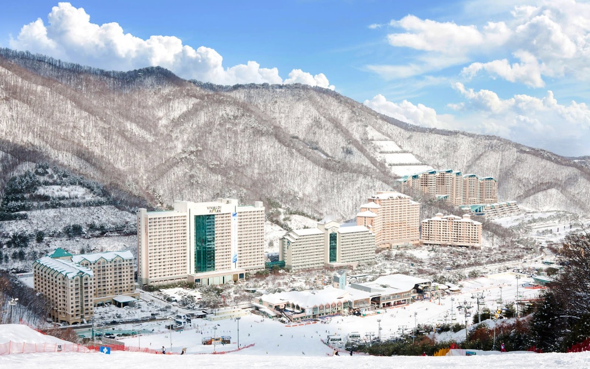 Vivaldi Park Ski Resort with snow-covered buildings and mountains in the background.