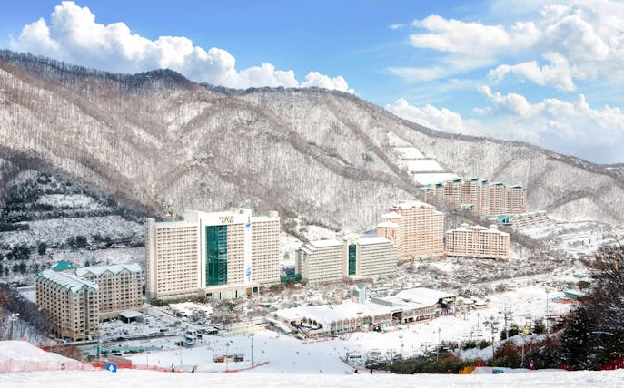 Vivaldi Park Ski Resort with snow-covered buildings and mountains in the background.