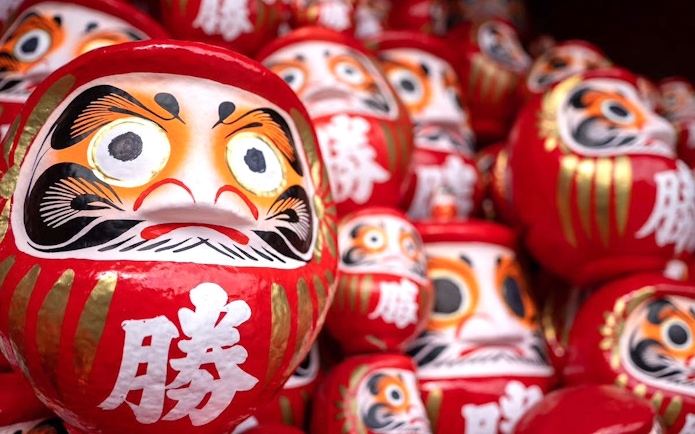 Kachi Daruma dolls on offering shelf at Katsuo-ji Temple, Japan.