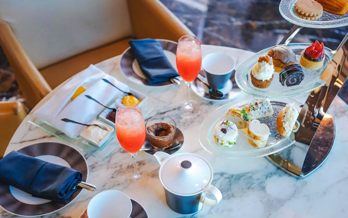 Afternoon tea with pastries and drinks at The Observation Deck at 300, Etihad Tower, Abu Dhabi.