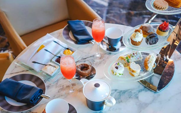 Afternoon tea with pastries and drinks at The Observation Deck at 300, Etihad Tower, Abu Dhabi.