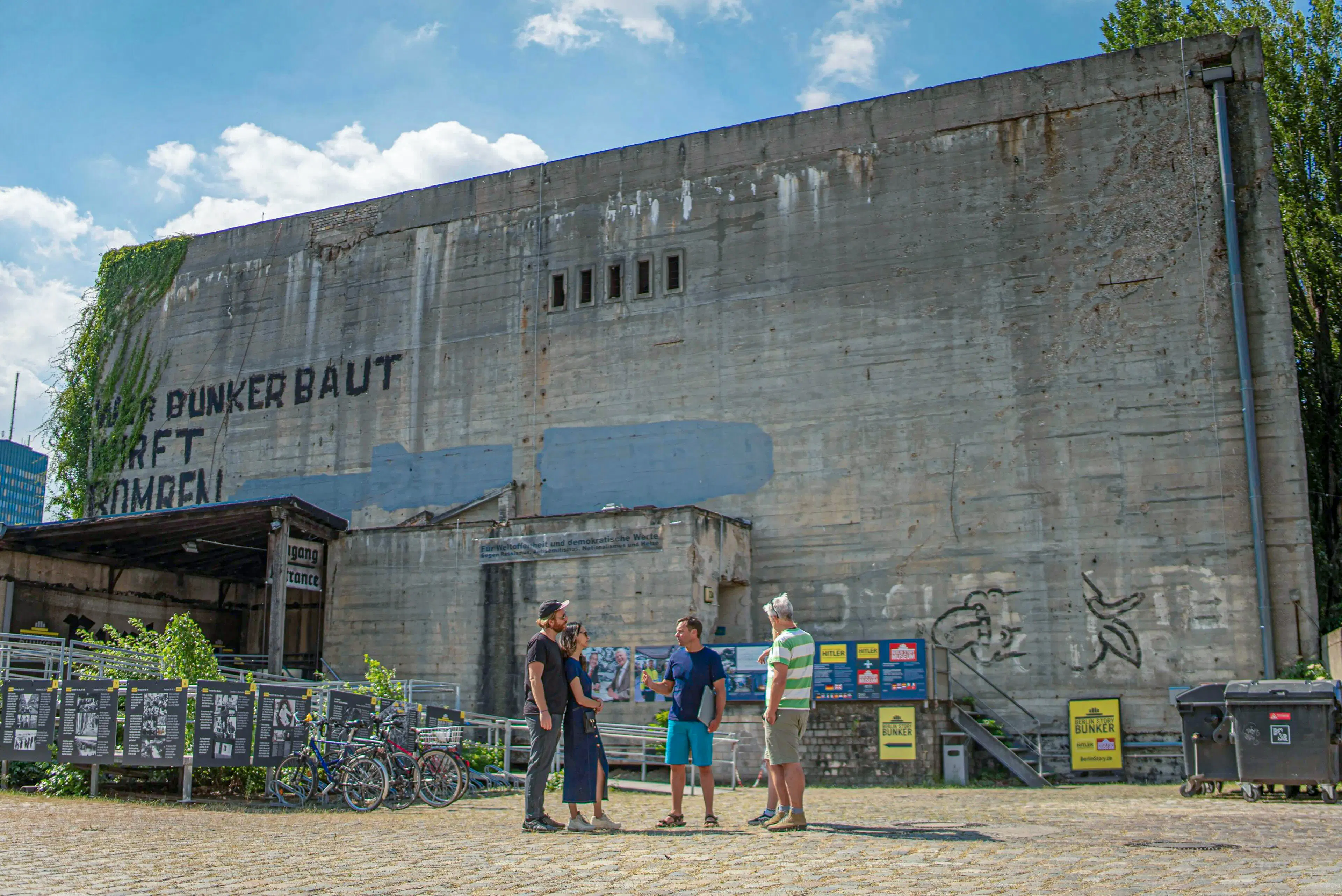 Visitors outside Berlin Story Bunker, Berlin, discussing historical exhibits.