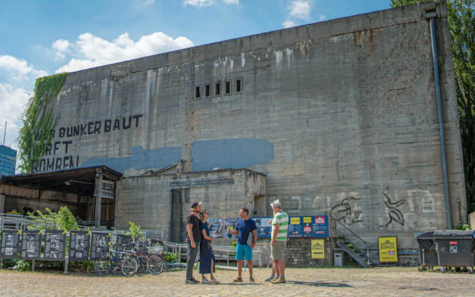 Visitors outside Berlin Story Bunker, Berlin, discussing historical exhibits.