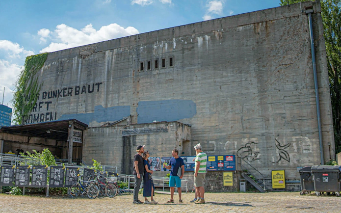 Visitors outside Berlin Story Bunker, Berlin, discussing historical exhibits.