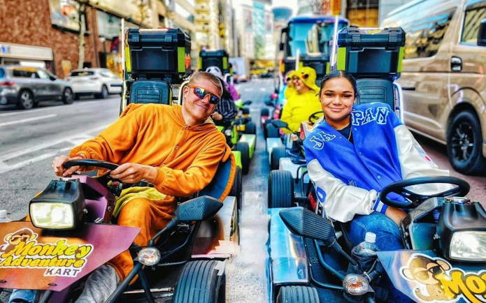 Go-kart riders in costumes on a street during the Asakusa, Skytree & Akihabara 60-Min Go-Karting Experience.