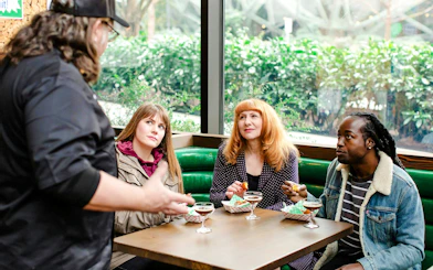 Group enjoying cocktails and snacks during Seattle Happy Hour Tour.