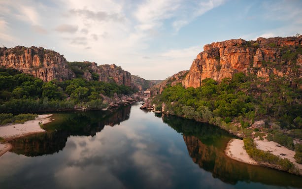 Kakadu National Park river view with rocky cliffs and lush greenery, Australia.