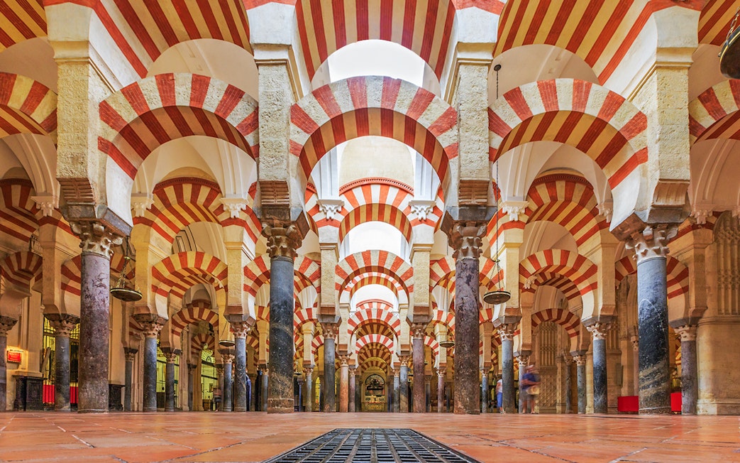 Córdoba Cathedral-Mosque interior with red and white arches and columns.