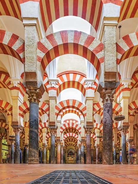 Córdoba Cathedral-Mosque interior with red and white arches and columns.