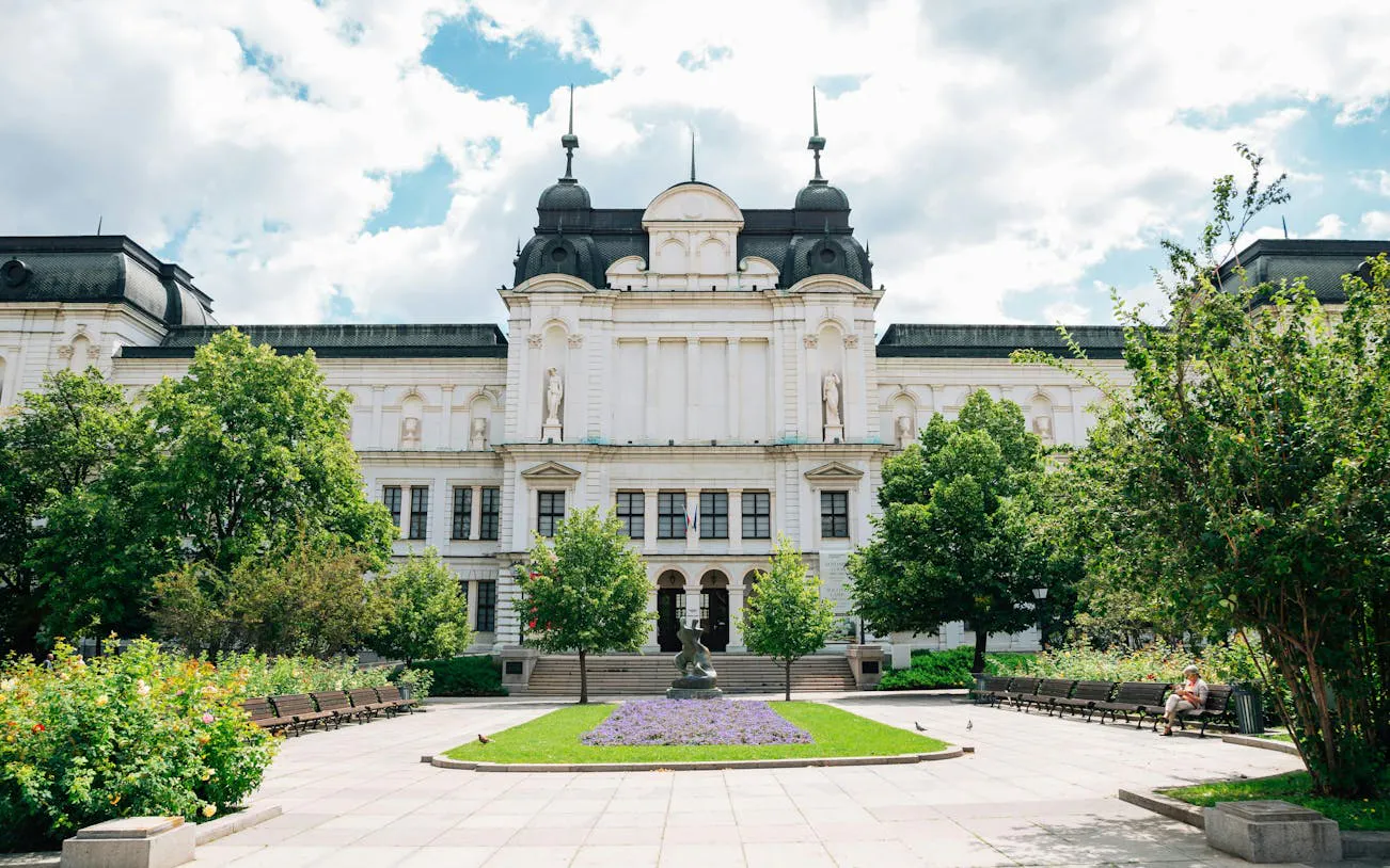 National Gallery building in Sofia with garden and statue in foreground.