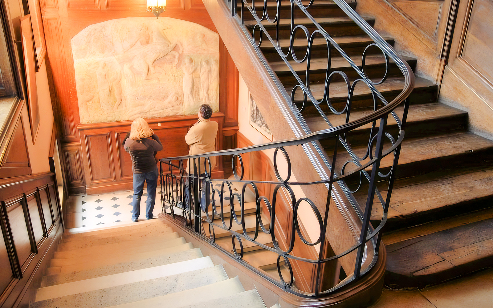 Visitors viewing a relief sculpture inside The Victor Hugo House, Paris.