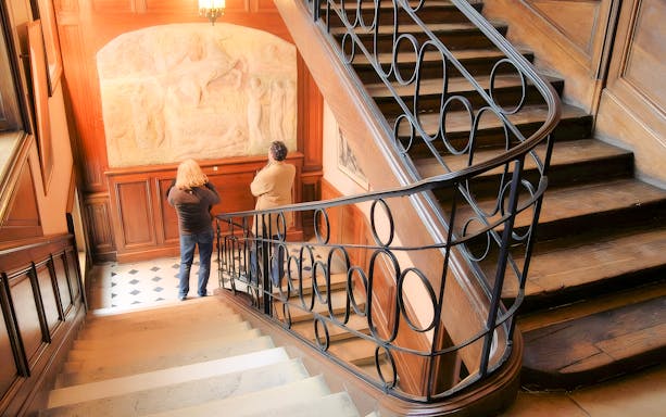Visitors viewing a relief sculpture inside The Victor Hugo House, Paris.