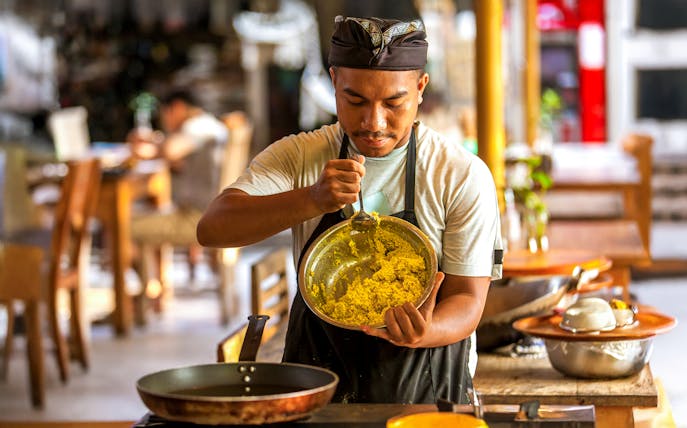 Chef preparing traditional dish at Bakas Cooking Class in Canggu.