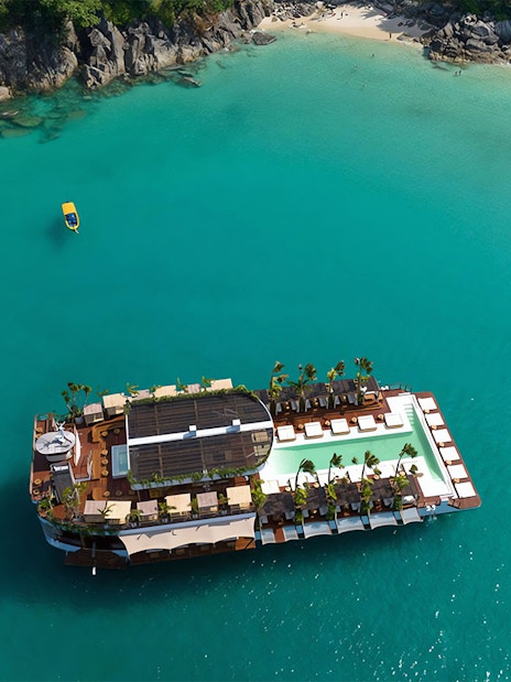 Aerial view of Yona Beach Club floating on turquoise waters, Phuket.
