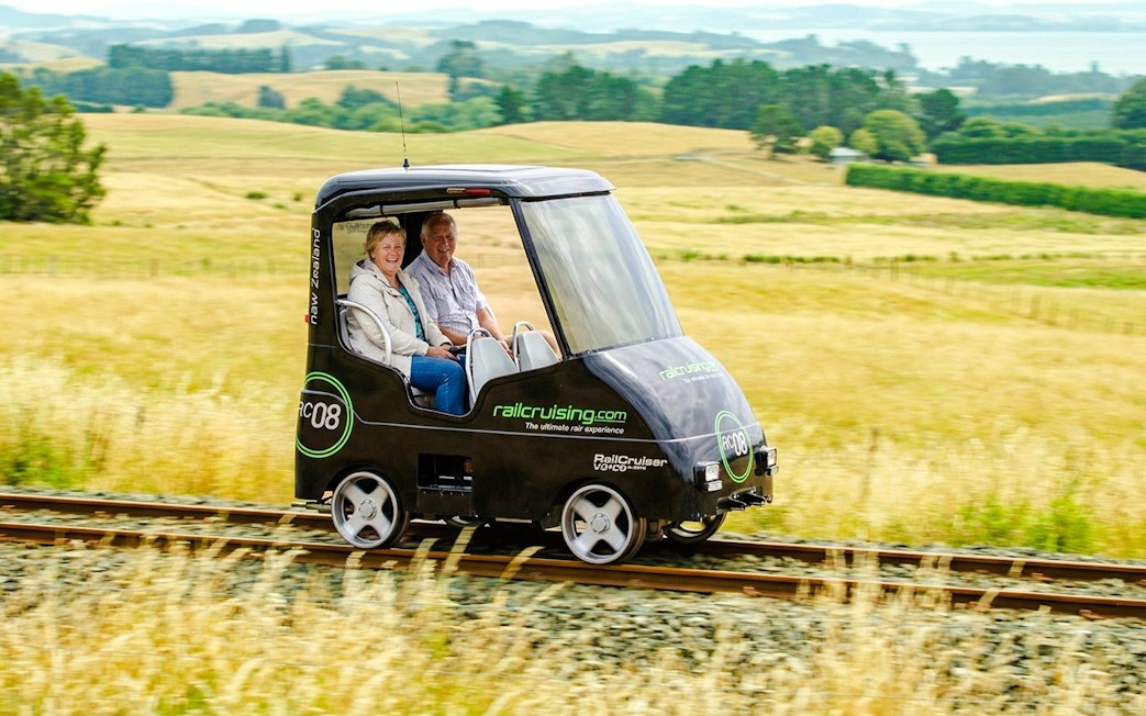 Self-drive rail car on tracks through Ngongotaha countryside, New Zealand.