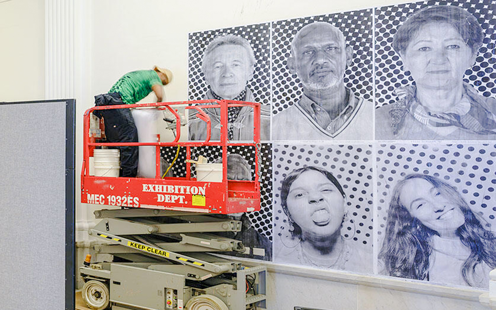 American Museum of Natural History exhibit on climate and health, featuring portraits and interactive displays.