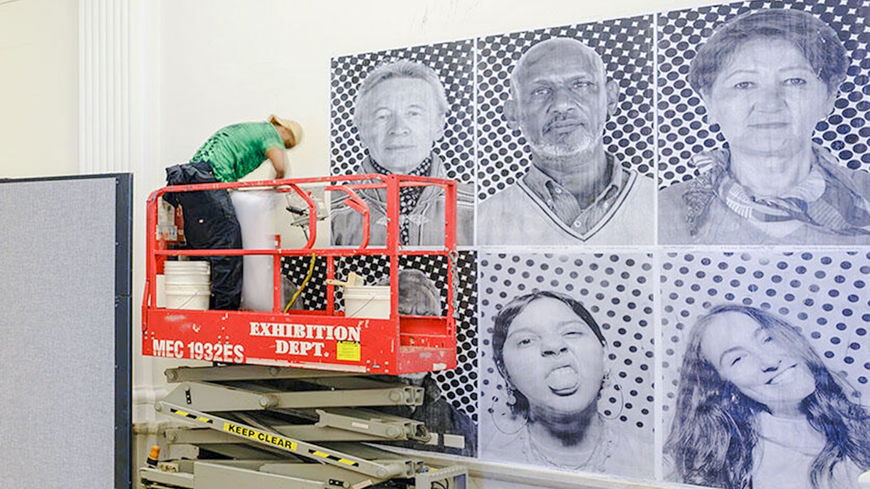 American Museum of Natural History exhibit on climate and health, featuring portraits and interactive displays.