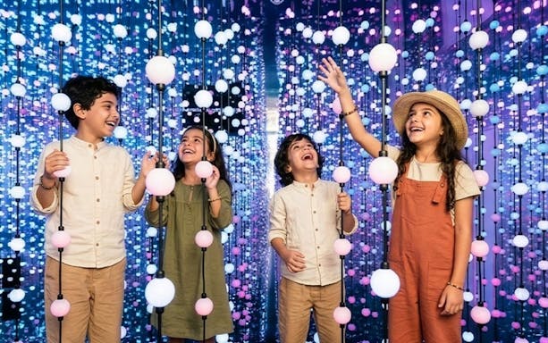 Kids enjoying interactive light display at Dopamine Land, Dubai.