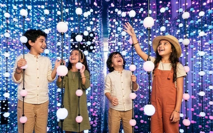 Kids enjoying interactive light display at Dopamine Land, Dubai.