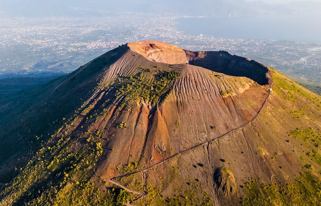 Mount Vesuvius crater with surrounding landscape, part of a Rome to Pompeii and Naples day trip.