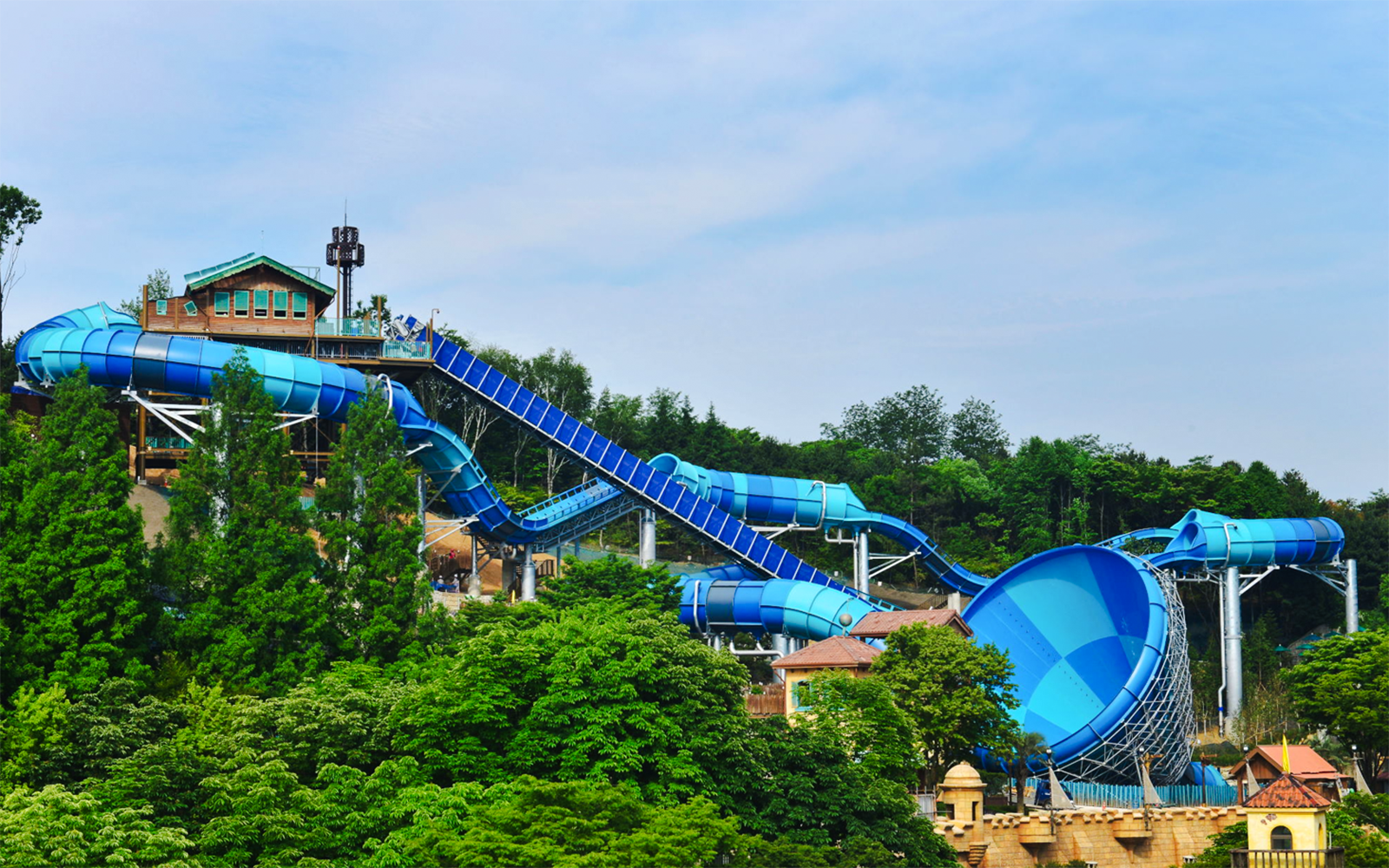 Big water coaster at Caribbean Bay Water Park surrounded by lush greenery.