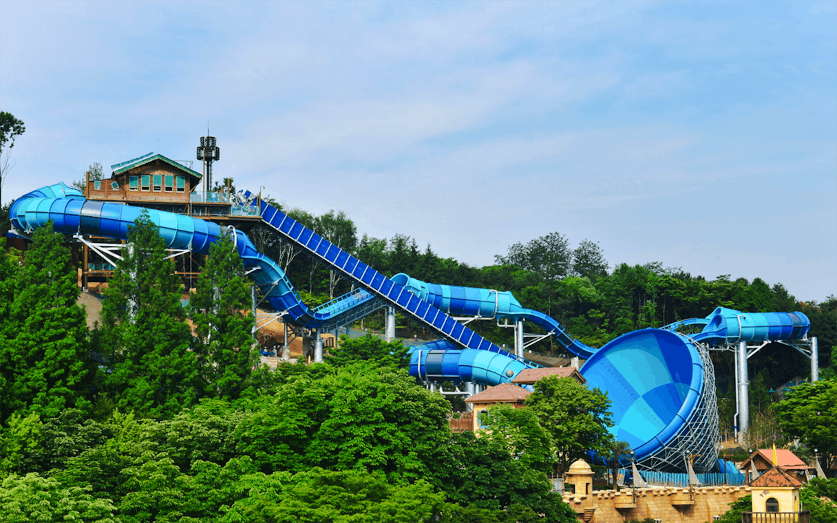 Big water coaster at Caribbean Bay Water Park surrounded by lush greenery.