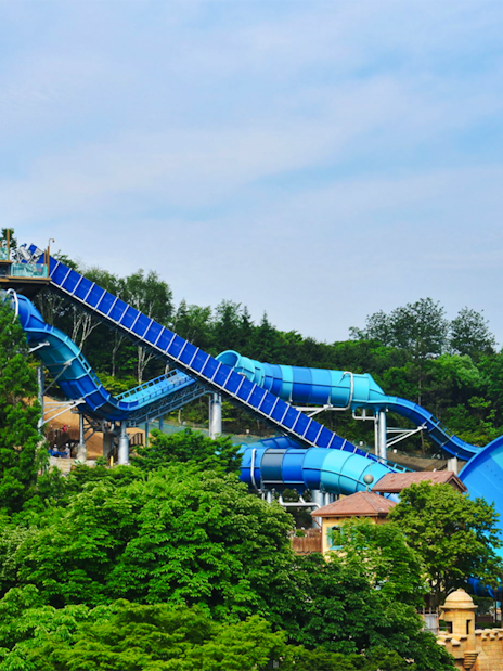 Big water coaster at Caribbean Bay Water Park surrounded by lush greenery.