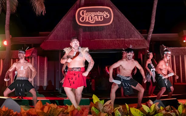 Traditional Polynesian play at Germaine's Luau, Oahu, Hawaii, featuring dancers in cultural attire.