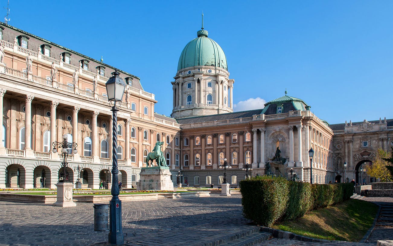 Hungarian National Gallery exterior with statue and dome in Budapest.